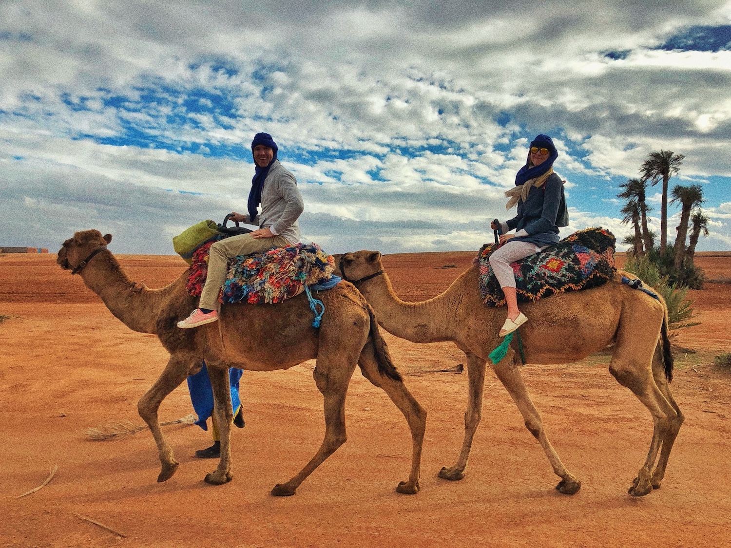 a couple on camels in marocco